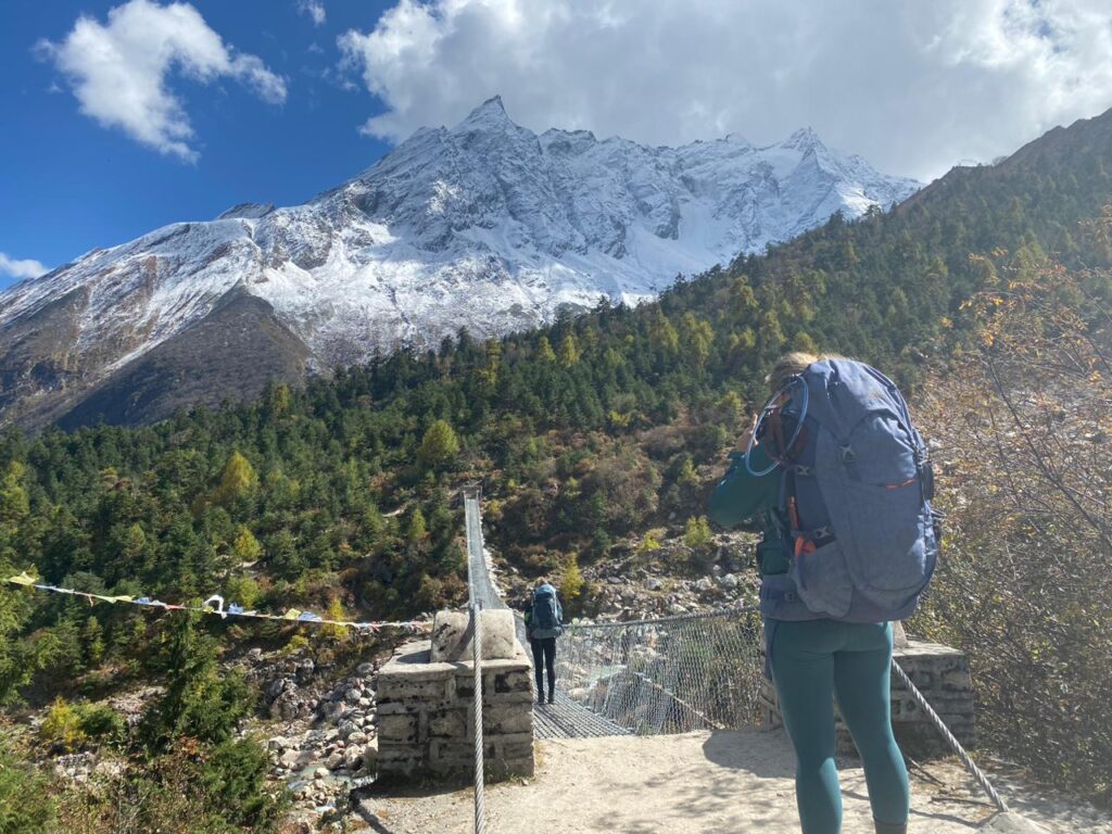 Crossing suspension bridge on manaslu trek